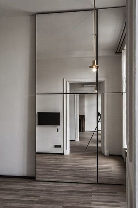 Making Mirrored Walls Modern: Seven Ideas to Steal | Apartment Therapy Mirrored Walls, Minimalism Living, Big Mirror, Interior Minimalista, Mirrored Wall, Wooden Floors, Modern Mirror, Mirror Designs, Modern Apartment