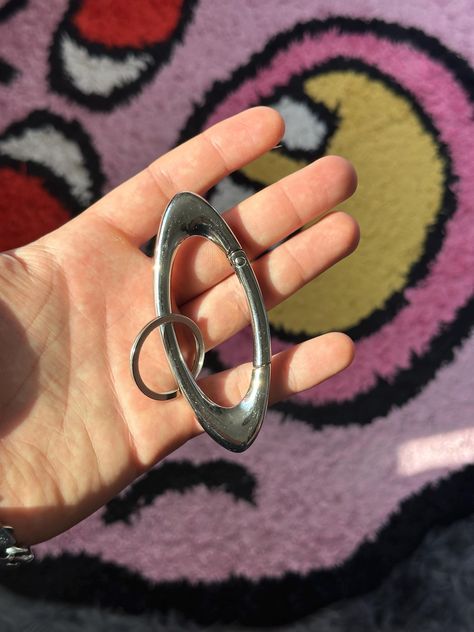 Silver and Black Carabiner! Size Length: 3.5 in Width: 1.2 in Made of high-quality Iron Alloy  It has a good weight to it and is very sturdy, it is designed to last :) Keychain in the final photo is also on my page, just an example of how to style it :) Shipping 95% chance it will be there in under 14 days I Have a longer shipping time stated for the small chance it is not and there is trouble with the shipping process. If there are any problems I will do all I can to help DM me with any questio Cyberpunk Y2k, Punk Mode, Chains Aesthetic, Jewelry Minimal, Carabiner Keychain, Y2k Jewelry, Key Clip, Grunge Punk, Futuristic Design