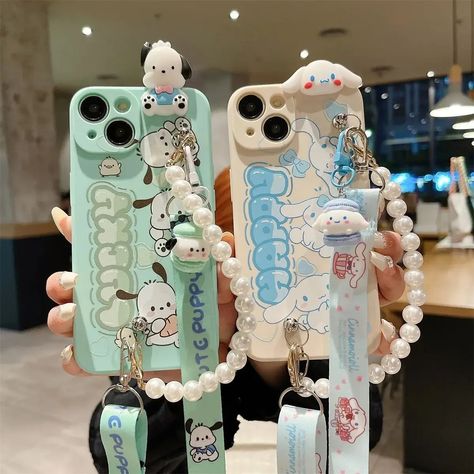 Infuse your day with the sweetness of Sanrio's Cinnamoroll or Pochacco! These soft silicone iPhone cases offer a perfect blend of cuteness and durability. Featuring your favorite characters in delightful designs, they provide excellent anti-drop protection. Ideal for Sanrio lovers seeking to add a touch of whimsy to their phones. A must-have accessory for any kawaii collection! Material: High-quality Silicone Style: Cute Sanrio Cinnamoroll and Pochacco, Charms, Wristlet Strap, Crossbody Strap Feature: Water-resistant, Back Protective Shock-Proof, Scratch-Resistant, Anti-Skid, Dirt-resistant Phone Crossbody Strap, Phone Cases With Charms, Cute Phone Accessories, Pochacco Phone Case, Aesthetic Phone Accessories, Sanrio Phone Case, Cinnamoroll Phone Case, Phone Cases Cute, Kou Diabolik Lovers