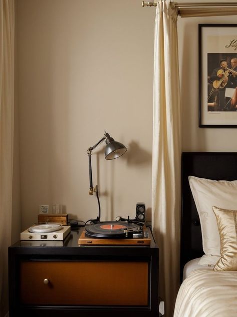 Create a vintage jazz aesthetic for your bedroom by incorporating a vinyl record player as a bedside table. Hang a large poster featuring iconic jazz musicians and drape a velvet curtain behind your bed for a glamorous touch. Vintage Jazz Aesthetic, Jazz Bedroom, Jazz Aesthetic, Aesthetic Bedroom Decor, Vinyl Record Player, Jazz Musicians, Velvet Curtains, Large Poster, Record Player