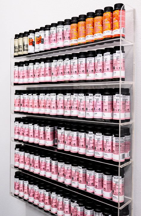 Acrylic wall hanging shelf with hair color toner bottles organized in a unique and practical manner. Shades Eq Shelf, Hair Color Wall Organizer, Salon Suite Shelving, Organize Nail Polish Storage, Hair Color Bar Ideas Salons, Redken Shades Organization, Salon Color Bar Ideas Storage, Hair Salon Color Room Ideas, Color Station Hair Salon