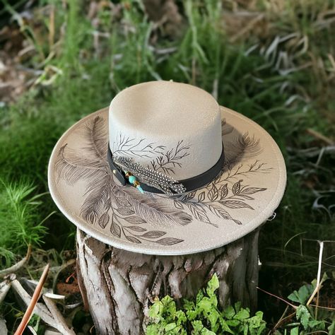 Grey color wide brim Bolero Hat burned using pyrography techniques. Each hat is burned freehand. No stencil, therefore each hat is a one of a kind. Each Hat is sealed with a weather proofer, good for up to 12 months. Hats made by PIPER also come with a signature travel bag and crafted Macramé Wall Hanger. Diy Leather Hat, Western Hat Styles, Hat Burning Ideas, Hat Burning Designs, Burning Hats, Burnt Hats, Cowboy Hat Crafts, Burned Hats, Bolero Hat