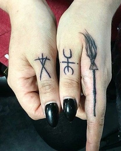 In a society captivated by grandiose ink masterpieces, small hand tattoos serve as a subtle yet impactful way to express your individuality. Oh yes, the days when hand tattoos were reserved for elements of questionable occupations only are far and gone, and we cannot be happier about it Occult Finger Tattoo, Finger Tattoo Witch, Tiny Witch Tattoo Finger, Broom Finger Tattoo, Finger Tattoos Spooky, Alternative Finger Tattoos, Pentagram Finger Tattoo, Cute Thumb Tattoos, Horror Finger Tattoos