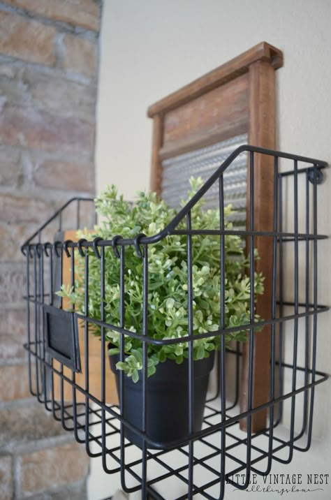 Farmhouse Style: Decorating with Wire Baskets Wire Basket Under Bench, Wall Wire Basket Decor, Metal Basket Decor Ideas Farmhouse Style, Wire Basket Wall Decor Ideas, Wire Baskets On Wall, Decorating With Wire Baskets, Basket Hanging On Wall, Wall Basket Decor Farmhouse, Wire Basket Decor Ideas