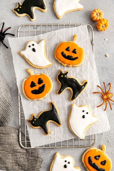 Halloween sugar cookies decorated with royal icing: orange Jack-o'-lanterns with black facial features, black cats with glowing yellow eyes, and white ghosts with black details. Halloween Icing, Black Cat Cookies, Sugar Cookies From Scratch, Halloween Sugar Cookies Decorated, Sugar Cookies With Royal Icing, Cookies With Royal Icing, Halloween Cookies Decorated, Halloween Sugar Cookies, Sugar Cookie Icing