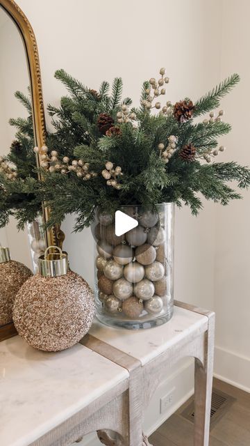 Ashley Savage | Home Decor on Instagram: "Ornament Vase Centerpiece Such an easy and fun Christmas DIY to make! Grab a couple coordinating vases and a pack of ornaments to make this arrangement for a Christmas party or just as a centerpiece in your home for the holidays! You could even add some fairy lights in there to make it twinkle at night!  • • • • #christmasdecor #christmasdiy #christmashome #diychristmasdecor #christmaspartyideas #christmasideas #christmas" Christmas Ornament Vase, Christmas Decor Vase Ideas, Vase With Christmas Greenery, Vase With Christmas Ornaments, Christmas Glass Vase Decor, Large Glass Vase Christmas Decor, Christmas Greenery In Vase, Glass Vase Christmas Decor Ideas, Holiday Vase Filler Ideas