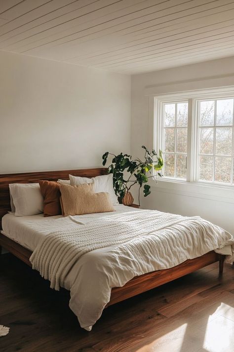 Create a peaceful minimalist bedroom by embracing clean lines, neutral colors, and smart storage solutions. Opt for simple furniture with hidden storage to keep the space clutter-free. Add warmth with natural wood tones and soft textiles for a calming atmosphere. 🛏🌿 Small Calm Bedroom, Primary Bedroom Minimalist, Minimal Natural Bedroom, Simple Neutral Bedroom Decor, Clean Bedroom Inspiration, Bedroom White And Wood, Airy Bedroom Aesthetic, Minimalist Master Bedrooms Decor, Simple Clean Bedroom