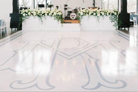 A Large wedding  dance floor with a blue in the middle and large white florals on the stage Wedding Dance Floor With Initials, Monogrammed Dance Floor, Blue Dance Floor, White Timeless Wedding, Monogram Dance Floor, Timeless Wedding Theme, Dance Floor Wrap, Classic Southern Wedding, Dance Floor Vinyl