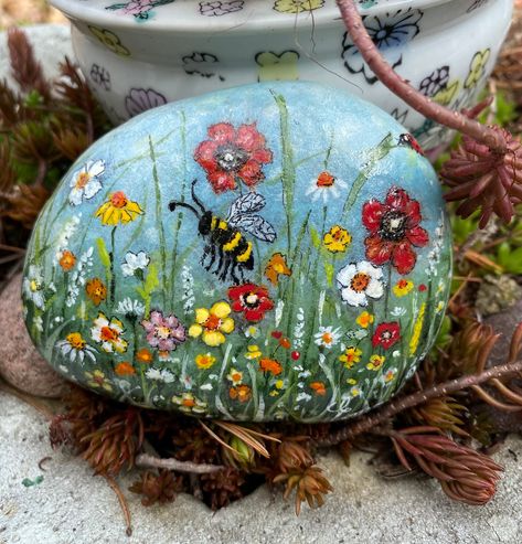 This beautiful hand painted stone has a different painting on each side!  With two lovely flower fields, this stone makes the perfect Spring or Summer decorative item. This stone would make the perfect piece for your garden, home, classroom or office, or would make a perfect gift for family or friends! Stone measures 3.5" x 2.75" x 1.5", ships in 1-3 business days. Please note that all stones come in gift boxes, display stand is not included. Please contact my shop for questions or custom inquiries. Dot Art Rock Painting, Welcome Painted Rocks Front Doors, Painted Rock Dragonfly, Dragonfly Rock Art, Flowers Painted On Rocks, Paintings For Friends, Hand Painted Rocks Ideas, Painted Rocks Flowers, Decorative Garden Stones