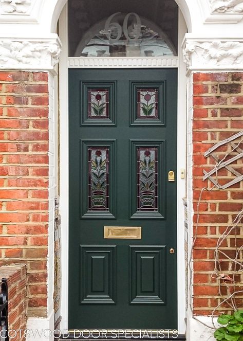 Beautiful Georgian front door with an original stained glass flower design. Georgian front doors were characterised by their six panelled construction. As the era progressed, glass began to be inserted in place of wood in the upper panels to increase light flow. This London homeowner has opted for four gorgeous leaded glass panels and decorative mouldings to echo the opulence of the Georgian period Victorian Front Door, Green Front Door, Victorian Front Doors, Georgian Doors, Green Front Doors, Victorian Door, House Restoration, Wooden Front Doors, House Front Door