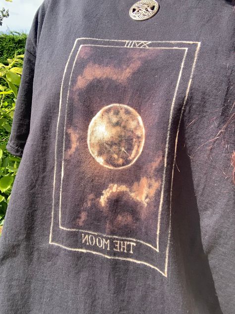 Hand painted, bleached tshirt, with moon tarot card design. Moon Bleach Shirt, Painted Tarot Cards, Bleached Shirt Art, Cool Bleach Designs, Drawing On A T-shirt, Bleach Art Clothes Ideas, Painted Clothes Diy Shirts, Bleached Shirts Ideas, Painting On Clothes T Shirts