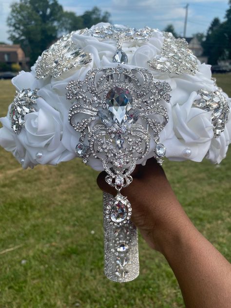 This luxurious bling bouquet is made with real touch artificial roses and silver brooches/gems. Roses are 3 inches wide. Size of bouquet shown is 10 inches wide at the top but can be ordered in a smaller size (8 inches). You may choose any color(s) for your rose bouquet. Please list any additional colors for your roses under "personalization." It will allow you to type a note to me. Please message me if you do not see your color(s). Brooches may vary but are available in silver, gold, or rose go