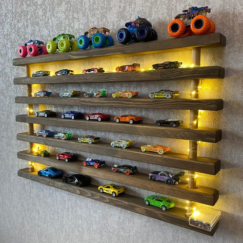 Toy Car Shelf: Show off your toy car collection with this wooden car shelf! We have combined 7 wooden shelves made of high quality wood. A unique product to display your toy cars! This would be the perfect birthday present for your loved ones!  The width of the wooden shelves is 2 inches. The distance between them is 1.75 inches. You can display about 60 toy cars with this product. Please message us if you would like to customize these dimensions. We can make it in any size you want. Product Dimensions:  30*18*2 inches.                                         76*46*5 cm. Personalization: Personalization is possible. We can laser engrave any word you want on the middle shelf.     We can customize product dimensions according to your wishes. Please message us for any customization request! T Hotwheels Storage Wooden, Toy Car Collection Display, Monster Truck Display Shelf, Hotwheels Bedroom Ideas, Hot Wheels Bedroom Ideas, Car Room Ideas For Boys, Toddler Boy Room Decor Ideas, Toy Car Shelf, Car Display Shelf