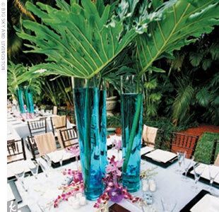 Blue palm leaf centerpiece Palmas, Water Centerpieces, Tropical Wedding Centerpieces, Non Floral Centerpieces, Tropical Centerpieces, Expensive Flowers, Unique Wedding Flowers, Wedding Floral Centerpieces, Flower Centerpieces Wedding