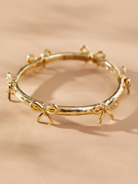 This delicate gold bow bracelet adds a touch of girly to your wrist. The gold bows stand out and the stretchy band ensures a comfortable fit for all-day wear. Dress it up or down, this bracelet is a versatile addition to any jewelry collection. Gold Bracelet Stack, Jewelry 2024, Aesthetic Accessories, Preppy Jewelry, Trending Jewelry, Jewelry Cute, Bow Bracelet, Gold Armband, Jewelry Accessories Ideas