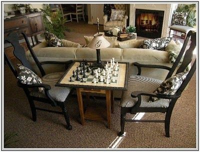 155 dream lane, chess table.  In family room. Chess Nook Living Rooms, Chess Table In Library, Game Area In Family Room, Chess Table Ideas, Chess Room Ideas, Puzzle Corner Living Room, Chess Board In Living Room, Living Room With Game Table, Chess Set Decor Living Rooms