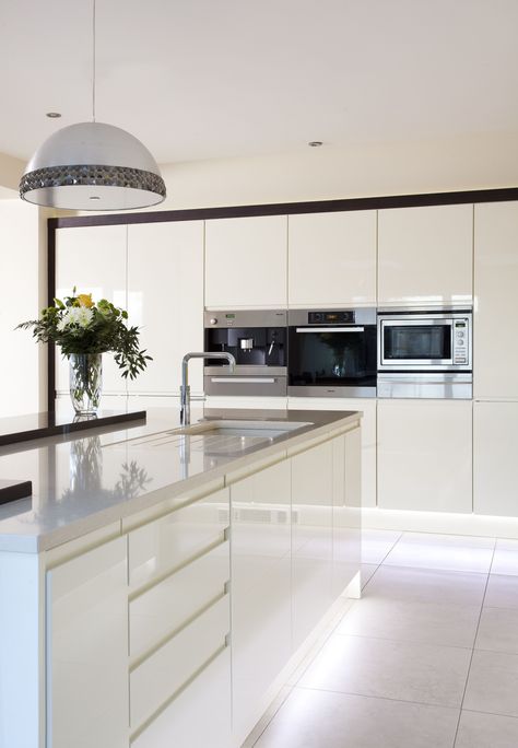 Sleek lines with this white gloss handleless kitchen and Silestone worktops. Gloss White Kitchen Island, White Gloss Handless Kitchen, Modern White Gloss Kitchen, White Kitchen Worktop Ideas, Gloss Kitchen Cupboards, White Kitchen Diner, White Handless Kitchen, White Gloss Kitchen Ideas, White Open Plan Kitchen