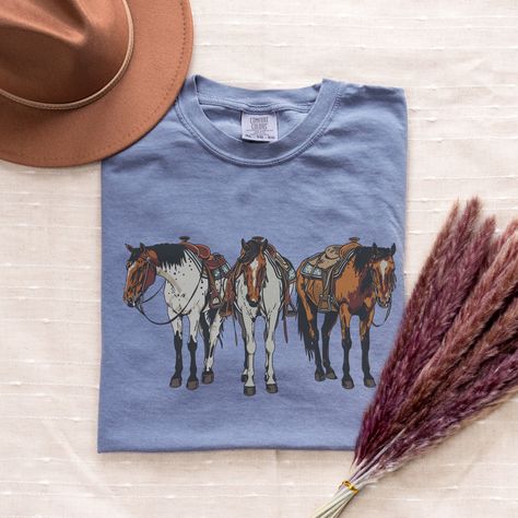 Embrace your inner cowgirl with our Western Shirt featuring a stunning horse girl design. This Long Live Cowgirl T-shirt combines western graphics with a touch of cowboy vibes, making it a top-selling tee that goes hard. Perfect for Yellowstone lovers and anyone who appreciates a dash of western charm in their wardrobe. PRODUCT INFO ~ Comfort Colors Unisex Shirt ~ 100% Ring-Spun Cotton ~ Printed using Direct To Garment style- Inks are printed directly into the fabric. ~ Colors may differ slightl Western Tee Shirts, Western T Shirts, Western Graphics, Cowboy Vibes, Cowgirl Tshirt, Western-themed Crew Neck T-shirt, Hoodie Design Ideas, Cowboy Graphic, Western Style Crew Neck T-shirt With Graphic Print