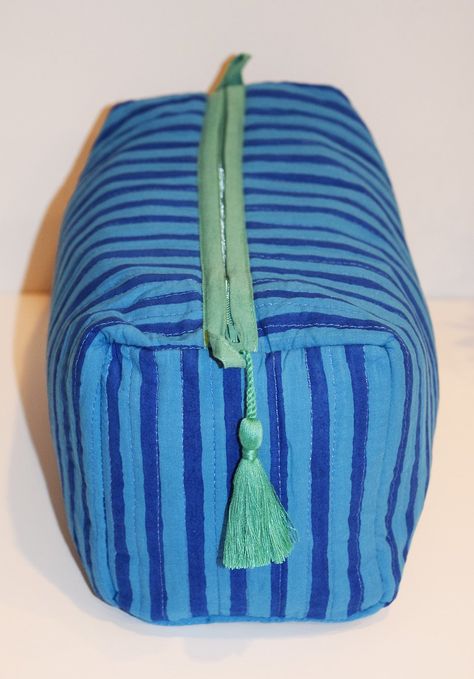 Our largest toiletry bag is gorgeous and functional. Fully lined with waterproof material + 4 interior pockets. Zipper closure with tassel trim. 100% cotton with decorative stitching 11" L x 5.5" H x 5" W YKK zipper closure with tassels Spot clean or machine wash on delicate cycle, cold water, inside laundry bag. Air dry. Sew Laundry Bag, Quilted Toiletry Bag, Large Toiletry Bag, White Boho Tops, Creative Textiles, Diy Bag Designs, Travel Toiletry Bag, Laundry Bags, Minimalist Bag