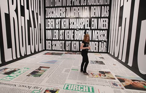 A young woman walks through an installation by artist Barbara Kruger at the exhibition ARTandPRESS. The exhibition shows works by artists who have interpreted the medium of newspapers. Newspaper Set Design, Newspaper Installation, Poetry Exhibition Design, Newspaper Exhibition, Exhibition Introduction Wall, Exhibition Wall Text, Wall Typography, Newspaper Wallpaper, Barbara Kruger