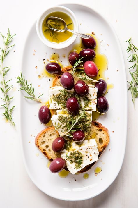 Indulge in a Mediterranean delight! Our Herb-Marinated Feta with Roasted Grapes on Crostini is the perfect fusion of tangy, sweet, and crunchy. A must-try appetizer! #MediterraneanCuisine #FetaCheese #RoastedGrapes #CrostiniLove #AppetizerGoals Mediterranean Food Photography, Appetizer Photography, Canape Ideas, Cheese Aesthetic, Marinated Feta, Mediterranean Appetizers, Roasted Grapes, Cheese Photography, Crostini Recipe