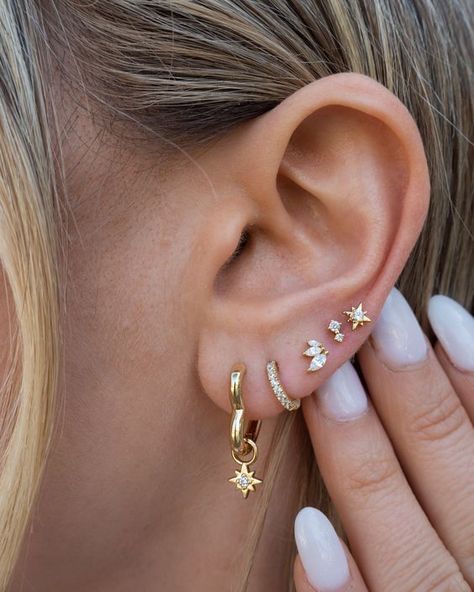 If you're looking for a huggie version of our Johnny earrings, these are it! These tiny hoops fit perfectly around little lobes. Huggie hoop earrings 14k gold plated with sterling base Cubic zirconia accents Protective coating, water resistant Sold as a pair Pretty Ear Stacks, Earring Inspo 3 Holes, 5 Ear Piercings, 3 Ear Piercings Ideas, 4 Lobe Piercings, Lobe Piercing Ideas, Ušný Piercing, Multiple Piercings Earrings, Ear Stacks