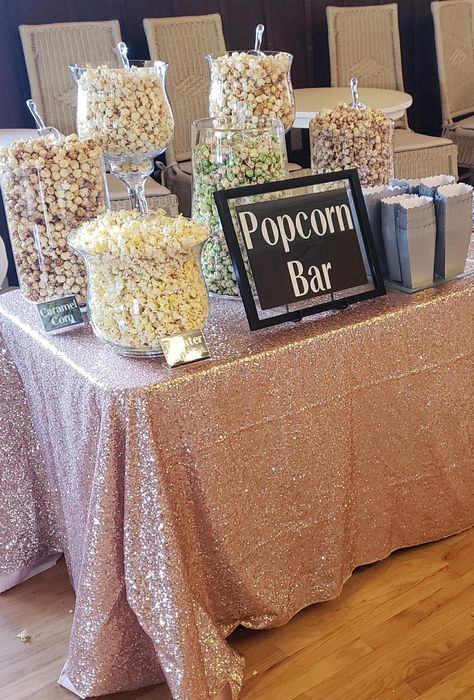 Popcorn buffet in large glass candy jars with a blush sequin. Popcorn Buffet Ideas, Candy Popcorn Bar, Popcorn Table Ideas, Popcorn Table, Popcorn Station Party, Popcorn Table Wedding, Elegant Candy Table Ideas, Sunday Funday Party Ideas, Popcorn And Candy Bar