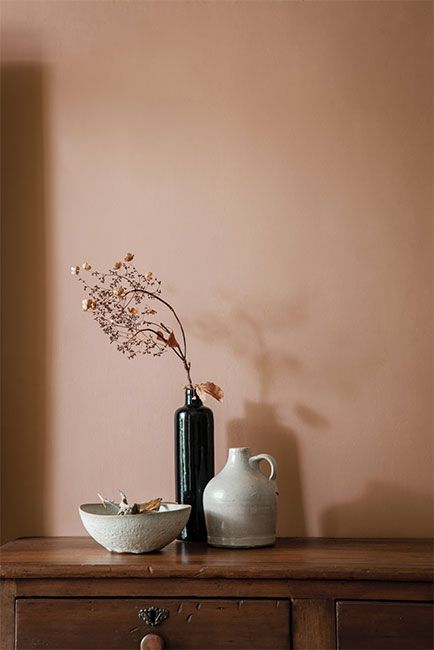 A vase, jug and bowl on a wooden dresser against a wall in a soft, pink-tinged brown paint color. - Benjamin Moore's Metallic Gold 2163-40. Via @benjamin_moore 2023 Interior Design, Brown Paint Colors, Pink Paint Colors, Handcrafted Tile, Purple Rooms, Wooden Dresser, Warm Home, Benjamin Moore Colors, Paint Color Palettes