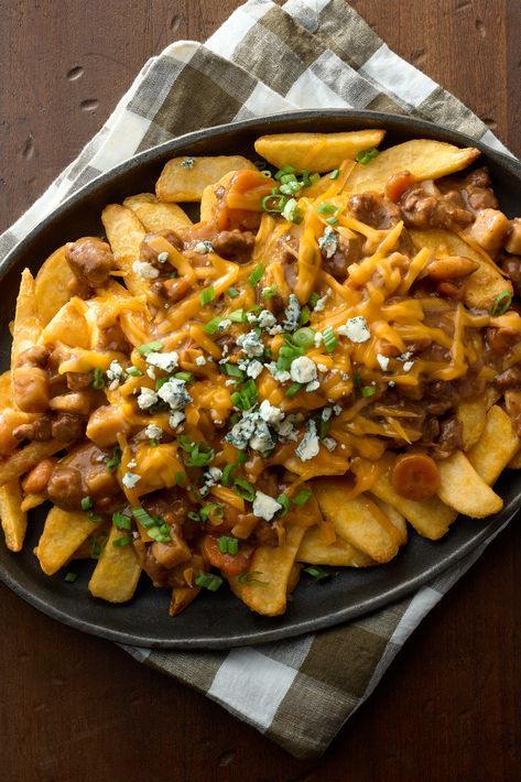 Loaded Beef Stew Pub Fries can be enjoyed as a hearty appetizer or a satisfying meal. Simply bake a bag of frozen steak cut French fries and pour a can of hot DINTY MOORE® Beef Stew over them. Sprinkle with cheese and chopped green onions, bake until the cheese is melted and bubbly. Perfect for sharing or indulging solo, these pub-style loaded fries deliver a delicious and convenient dining experience! Beef And Fries, Pub Fries, Hearty Appetizer, Dinty Moore Beef Stew, Frozen Steak, Romantic Breakfast, French Fries Recipe, Crispy French Fries, Loaded Fries