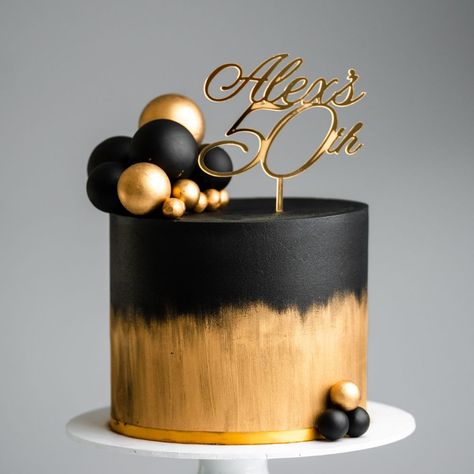 Brushed Gold and Black Sphere Cake Tutorial | buttercream, cake, ganache, icing, chocolate | Our cake decorating courses: https://vimeo.com/rosiesdessertspot/vod_pages And another black and gold cake coming your way! This one features a brushed... | By Rosie's Dessert Spot Golden Cake Design For Men, Black Ganache Cake, Black And Gold 2 Tier Cake, Simple Black And Gold Cake, Black And Gold Birthday Cake For Him, White Black And Gold Cake, Torte Schwarz Gold, Cake Designs Black And Gold, Black And Rose Gold Cake