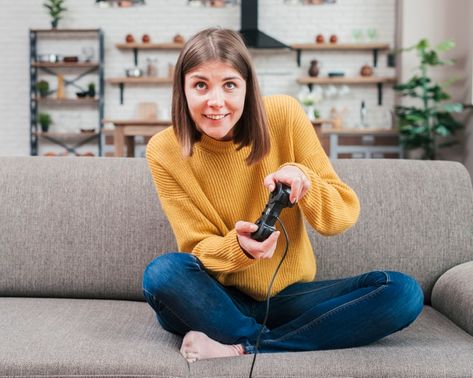 Smiling young woman having fun playing video console game at home Photo | Free Download Playing Console Pose, Playing Video Games Reference, Playing Video Games Pose, Gaming Pose Reference Drawing, Playing Video Game Poses Drawing, Playing Video Games Pose Reference, Playing Video Games Drawing Reference, Gamer Pose Reference, People Playing Video Games