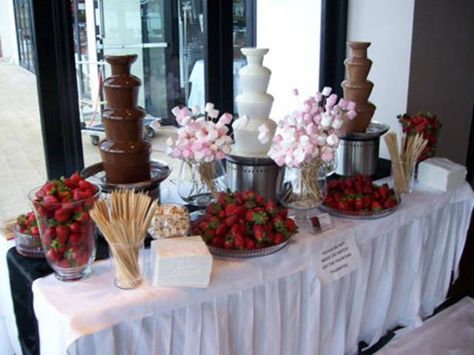 Chocolate Fountain Buffet, Chocolate Fountain Wedding Display, Wedding Chocolate Fountain Display, Fondue Wedding Bar, Chocolate Fountain Bar Ideas Wedding, Chocolate Fountain Wedding Ideas, Pink Chocolate Fountain Bar, Chocolate Fountain At Wedding, Chocolate Fountain Display Ideas