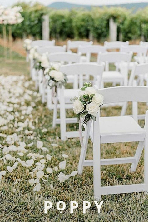 All-white wedding florals and stems give a minimalist wedding aesthetic with classic white flower bouquets and wedding aisle decor like free-falling flower petals. This classic wedding decor inspiration will delight your guests and leave happy memories for all. Wedding planning can be done on a budget with classic flower inspiration to create an ultra-romantic wedding theme for intimate micro-weddings and large weddings alike. White Roses Ceremony Aisle, Flowers On Aisle Chairs, White Wedding Flowers Isle, White Wedding Chair Decorations, Minimalist Wedding Ceremony Outdoor, Wedding Ceremony Outdoor Decorations, Cheap Aisle Decorations Wedding, White Wedding Chairs Ceremony, White Rose Isle Wedding