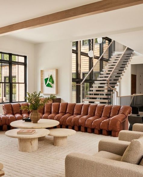 The living room in our Sag Harbor project. Making the most of space with ample seating and custom travertine tables, designed to perfectly inhabit the full expanse of the sofa. ⁠ ⁠ Photos by @nicole_franzen. Shearling Chair, Round Living Room, Living Room Renovation, Interior Design Guide, Leather Sectional Sofa, Trendy Living Rooms, Leather Couch, Chic Interior, Living Room Spaces