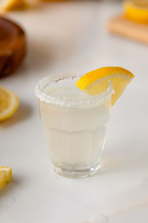 This lemon drop shot recipe is the sweet and tart shot version of the classic lemon drop cocktail and uses only lemon juice, vodka, simple syrup, and a sugar rim! Lemon Drop Shots Recipe, Lemon Drop Shot Recipe, Lemondrop Shot Recipe, Lemon Drop Shots, Lemon Drop Cocktail, Drop Shot, Shot Recipes, Lemon Wedge, Lemon Slice