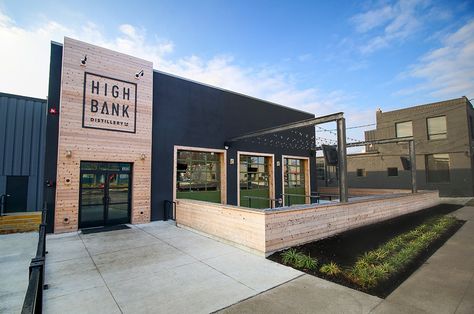 Entrance and patio space at High Bank Distillery Metal Building Renovation, Office Building Renovation, Shop Landscaping Ideas, Rustic Commercial Building, Exterior Warehouse Design, Metal Commercial Buildings, Commercial Metal Building Exterior, Commercial Patio Design, Business Entrance Ideas