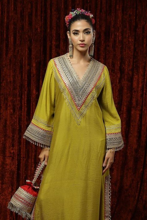 Lemon green woven chanderi silk kurta kaftan with gota, dori, badla embroidery on V neck, bell sleeves and border.
Component: 1
Pattern: Embroidered and Embellished
Type Of Work: Gota, Dori, Badla Work and Crystal Tassels
Neckline: V Neck
Sleeve Type: Bell Sleeves
Fabric: Silk Chanderi
Color: Green
Other Details: 
Crystal tassel details
Fuchsia pink contrast panels
Side slits
Note: The potli bag carried by the model is not for sale
Occasion: Sangeet,Haldi and Mehendi - Aza Fashions Badla Embroidery, Badla Work, Silk Kurti Designs, Stylish Kurtis Design, Kaftan For Women, Pink Contrast, Kaftan Designs, Latest Dress Design, Potli Bag