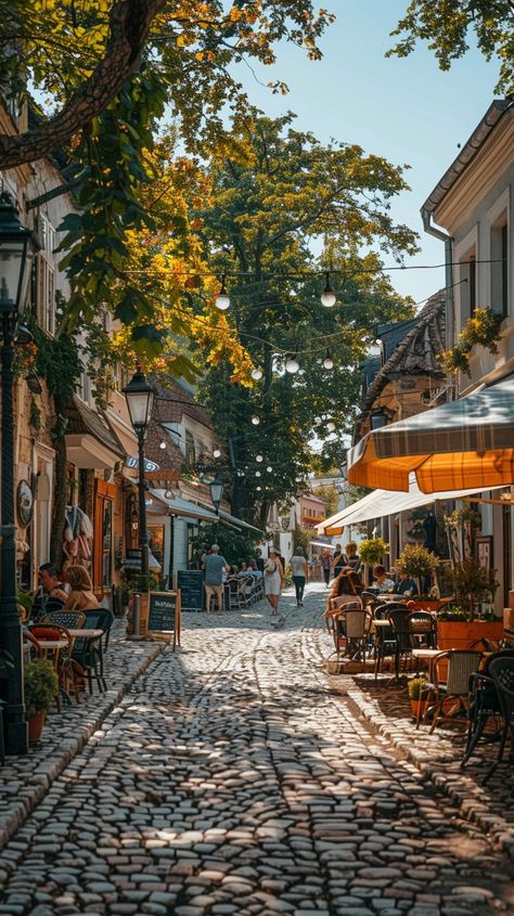 Cobbled Street Charm: Quaint #cobblestone street bustling with activity as people enjoy #outdoor #dining under the shade of #trees. #aiart #aiphoto #stockcake ⬇️ Download and 📝 Prompt 👉 https://stockcake.com/i/cobbled-street-charm_762832_1015428 Paris Cobblestone Streets, Cobble Stone Streets, Cobblestone Streets Aesthetic, Paris Street Cafe, Beach Rain, Dream Cafe, Cobblestone Street, Sidewalk Cafe, Stone Street