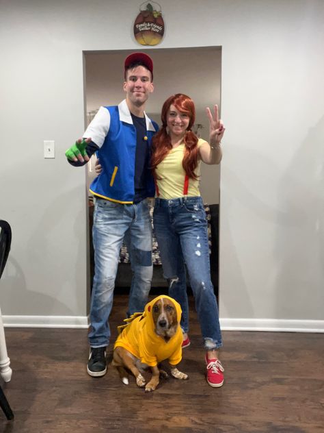 Couple Halloween Costumes With Pet, Couples Costume With Dog Halloween, Costume Ideas For Couples And Dog, Pokemon Dog Costume, Halloween Costume For Couple And Dog, Couple And Pet Halloween Costumes, Ash And Misty Costume, Matching Costumes With Dog, Couples And Dog Halloween Costumes