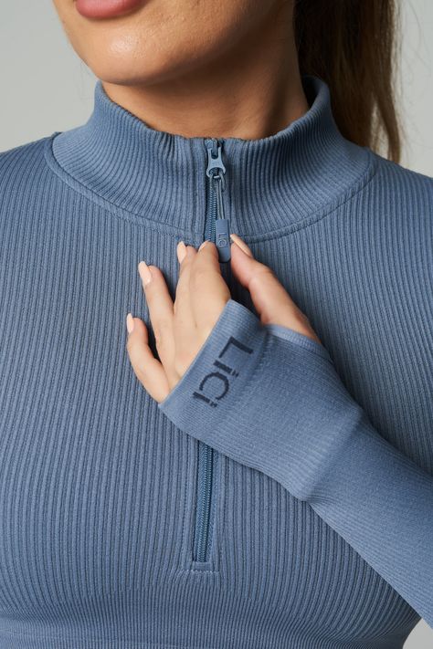 Customize your climate with the Seamless Ribbed Long Sleeve Half Zip. With long sleeves and a mock neck, this fitted pullover is exactly what you need for warm ups, cool downs and the stretches in between. The perfect fusion of performance and comfort. Our ribbed long sleeve is made from ultra-soft, premium fabric that is made to last. Full Coverage Double Lined Ribbed Fabric Half Zip Mock Neck Cropped Length Thumb Holes Ribbed Band Detail for Extra Support LiCi Logo placement center top back an Long Sleeve Activewear Tops, Tennis Dress Outfit, Sports Wear Outfits, Sporty Sweater, Activewear Photoshoot, Gymwear Outfits, Long Sleeve Activewear, Logo Placement, Easy Trendy Outfits