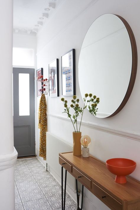 In a small and narrow hallway, bounce as much light around as possible with mirrors and by zoning your space. To avoid it feeling cramped and cluttered, create the illusion of space by adding mirrors which will reflect light, making the space seem wider and brighter. A slim, narrow console table is also ideal for the landline phone, some flowers and a bowl for keys. Get more hallway decor ideas at housebeautiful.com/uk. (Photo: Heal's) Hallway Table Decor, Entrance Hall Decor, Narrow Hallway Ideas, Hallway Mirror, Hallway Inspiration, Flat Decor, Narrow Hallway Decorating, Hallway Flooring, Hallway Designs