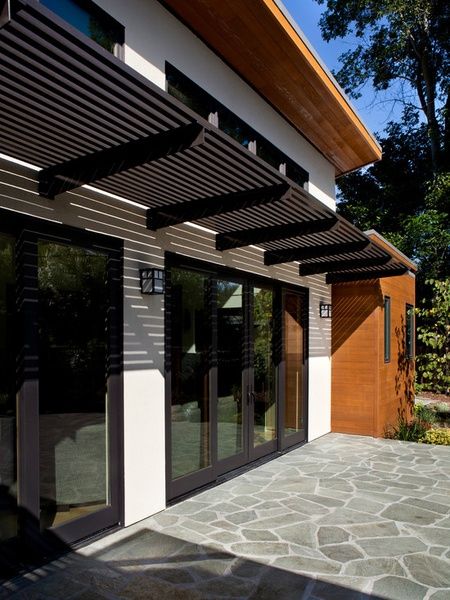 metal entry door awnings | Dark Metal Awning Over Patio Doors Door Canopy Modern, Awning Design, Metal Entry Doors, Pergola Modern, Front Door Awning, Metal Awning, Metal Front Door, Eksterior Modern, Pergola Ideas