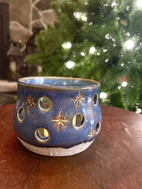 "Perfect for the winter season!  This is ceramic luminary was handmade on a pottery wheel.  It features hand carved stars that have been glazed in gold.  The base has a textured finish that is reminiscent of a snow covered ground. Each piece I make is unique and may have slight \"imperfections\" that really give it its own character.  Please see the detailed photos and videos.  And check my other listings!  Many of my pieces work well in groups together." Ceramic Snowman Handmade, Pottery For Christmas, Christmas Ceramic Decorations, Pottery Christmas Gifts, Winter Clay Projects, Ceramic Carving Ideas, Starry Night Pottery, Luminaries Ceramic, Winter Pottery Ideas