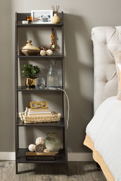 A bookcase makes an excellent nightstand-especially in small spaces! Use the Black Ladder Bookcase to add more storage and style to your bedroom. Bookshelf Bedroom Ideas Small Spaces, Bedside Ladder Shelf, Bookcase As Nightstand, Bookshelf Nightstand Ideas, Ladder Shelf Decor Bedroom, Ladder Shelf Styling, Bohemian Library, Bookcase In Bedroom, Nightstand Tall