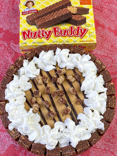 Box of Nutty Buddy bars next to a pie made from them and filled with a pudding and cream cheese mixture Nutty Buddy Cake, Nutty Buddy Pie Recipe, Nutty Buddy Pie, Nutty Bars Recipe, Nutter Butter Dessert, Cream Cheese And Peanut Butter, Pudding And Cream Cheese, Buddy Bars, Christmas Dessert Tray