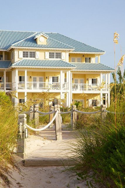 Coastal home with a fun yellow exterior Yellow Beach House, Sunset Cocktail, Beautiful Property, Blue Roof, Coastal House, Romantic Ideas, Dream Beach Houses, Turks Caicos, The Beach House