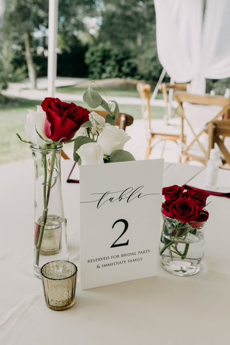 Red White Centerpieces Wedding, Minimalist Red Wedding Decor, Romantic Dinner Centerpiece, Red Table Numbers Wedding, Elegant Red Rose Centerpieces, Simple Red Centerpieces, Elegant Wedding Red Roses, Wedding Decor With Red Roses, Red And White Theme Wedding