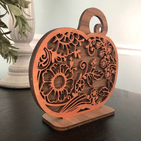 "This beautiful and intricate 6.5\" wooden pumpkin features a laser cut lace design stained with a shimmery orange wood dye and mounted to a walnut pumpkin backing. Contains a wooden stand for display. Makes a perfect Halloween or Autumn decoration!" Wooden Shelf Decor, Laser Cut Wood Jewelry, Wood Dye, Laser Cut Coaster, Laser Cut Christmas, Laser Crafts, Diy Laser Cut, Wood Craft Projects, Engraving Ideas