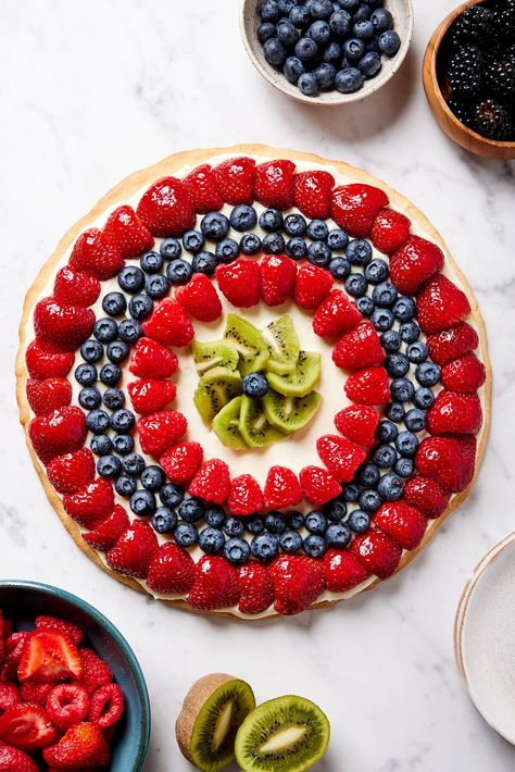 A nostalgic dessert, this fruit pizza uses a delicious homemade sugar cookie as a base. A cream cheese topping lays overtop, providing a sweet stage for the fruit. Customizable using any type of fruit, this treat can be created for any type of gathering. Fruit Pizza Ingredients, Green Pizza, Wyse Guide, Pizza Shapes, Strawberry Butter, Sugar Cookie Crust, Fruit Pizza Recipe, Homemade Sugar Cookies, Best Banana Pudding