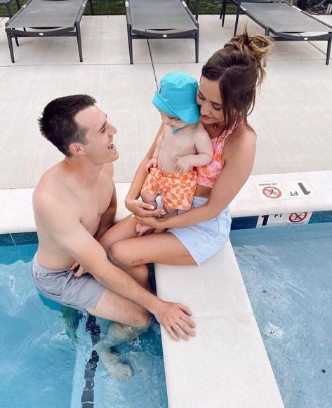 married couple with their baby boy at the pool Marcus Johns